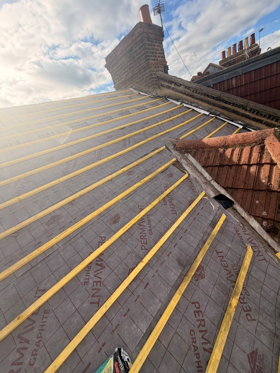 Breathable Permavent roofing membrane and new battens installed around a chimney